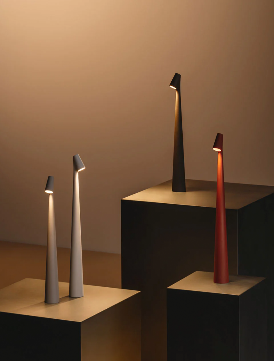 Nordic sculptural portable table lamp on a minimalist pedestal display