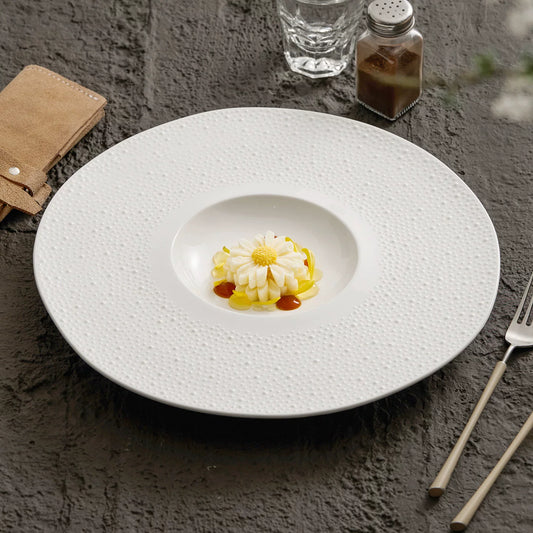 Off-white sesame point textured 12-inch round well plate.