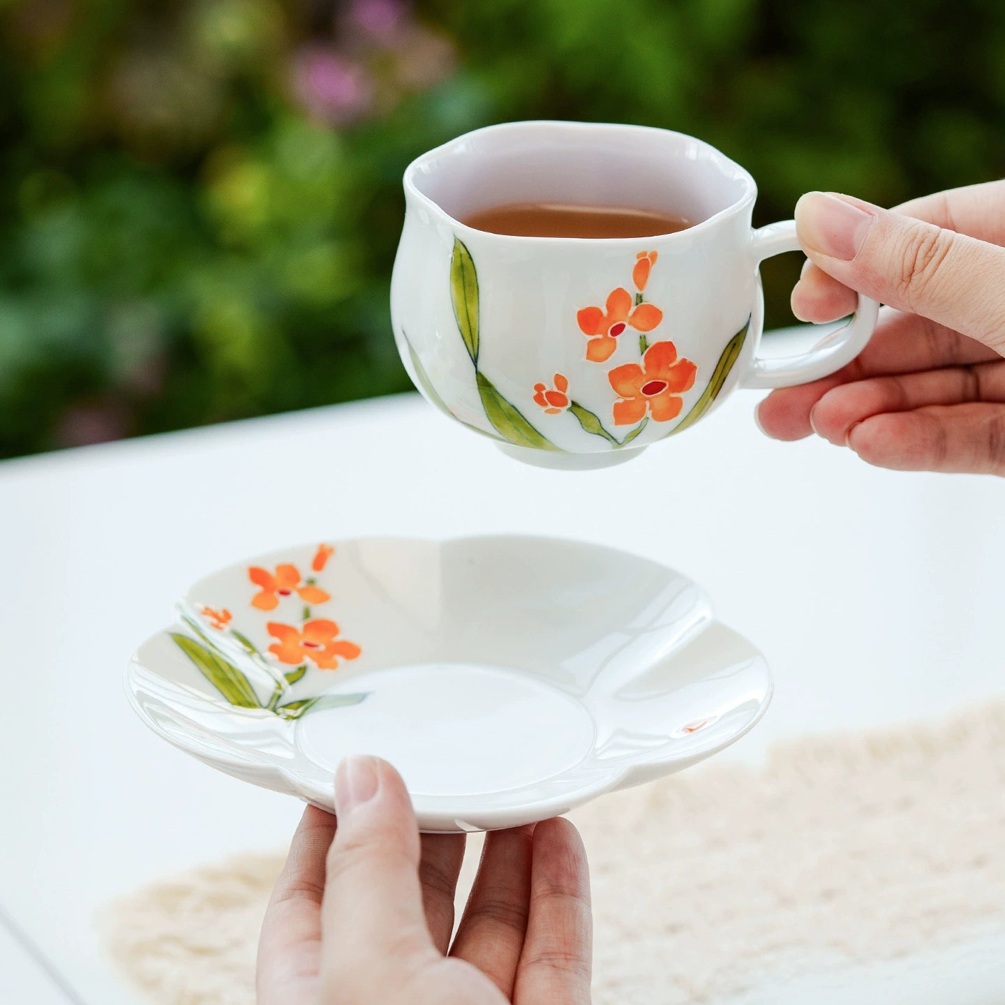 Orange blossom porcelain teacup with matching saucer