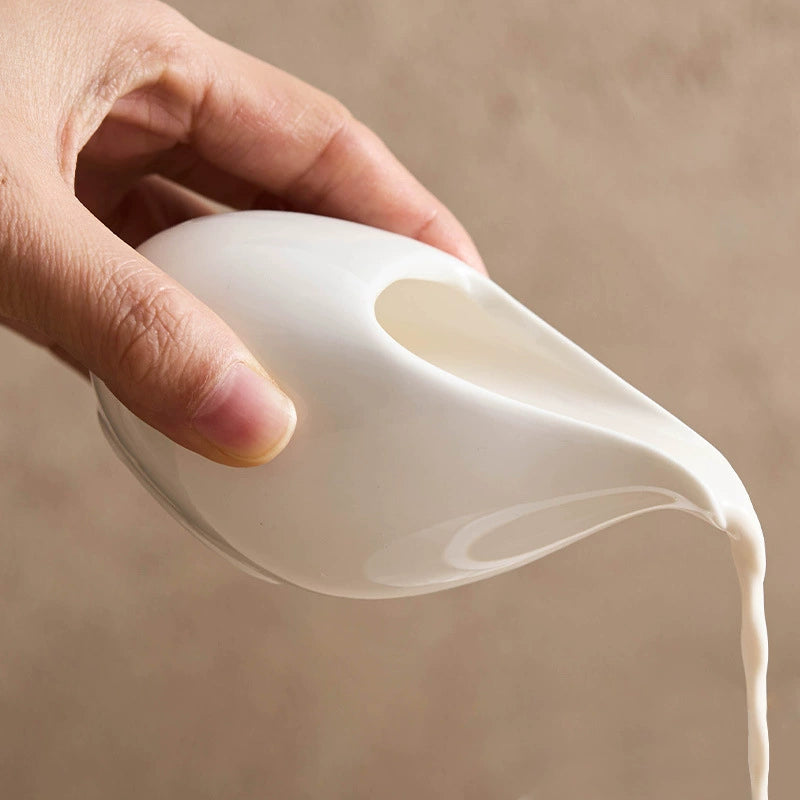 Organic curved ceramic sauce boat without handle, cobblestone series design.