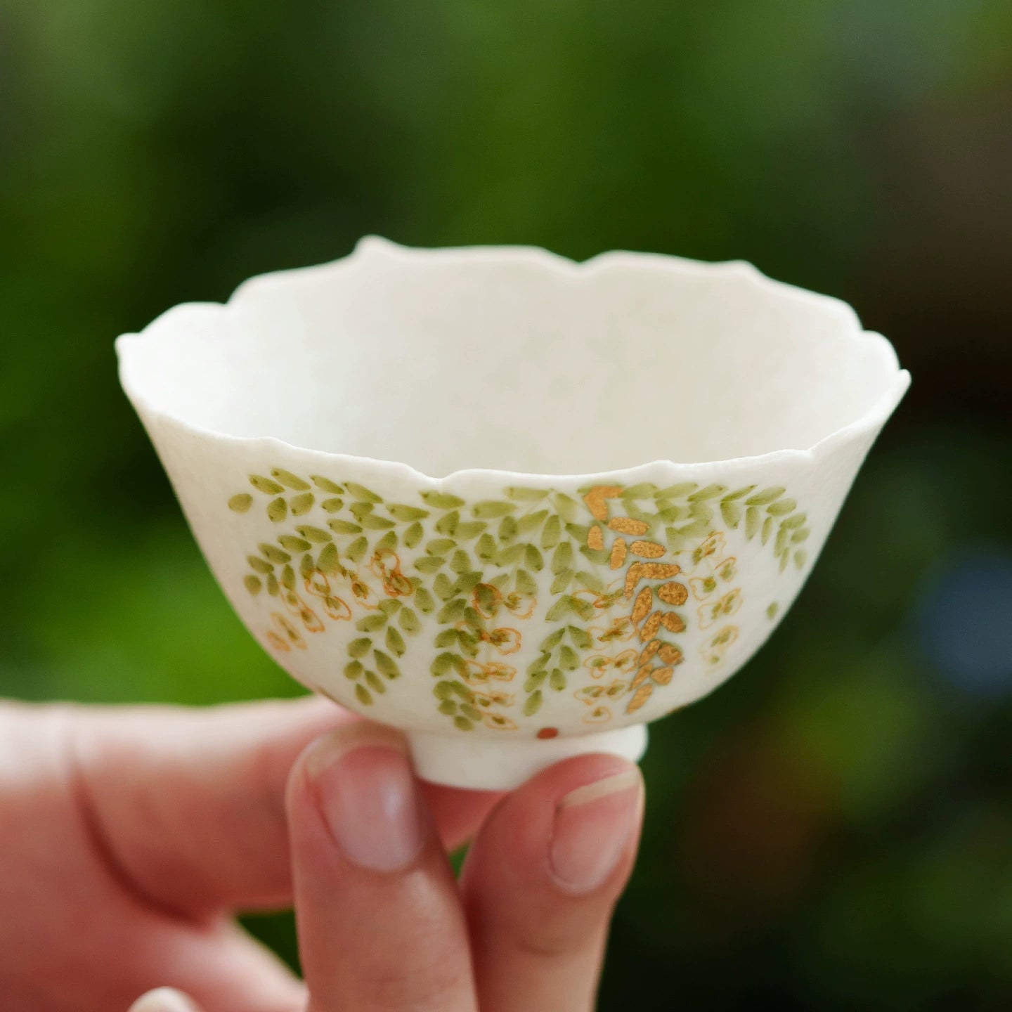 Petite ceramic teacup with leaf and gold accents