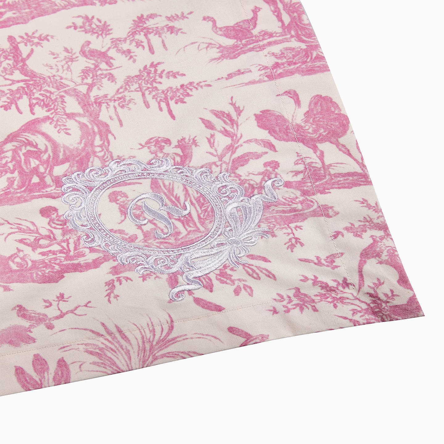 Pink Toile de Jouy napkin displayed alongside the matching collection on a pink
