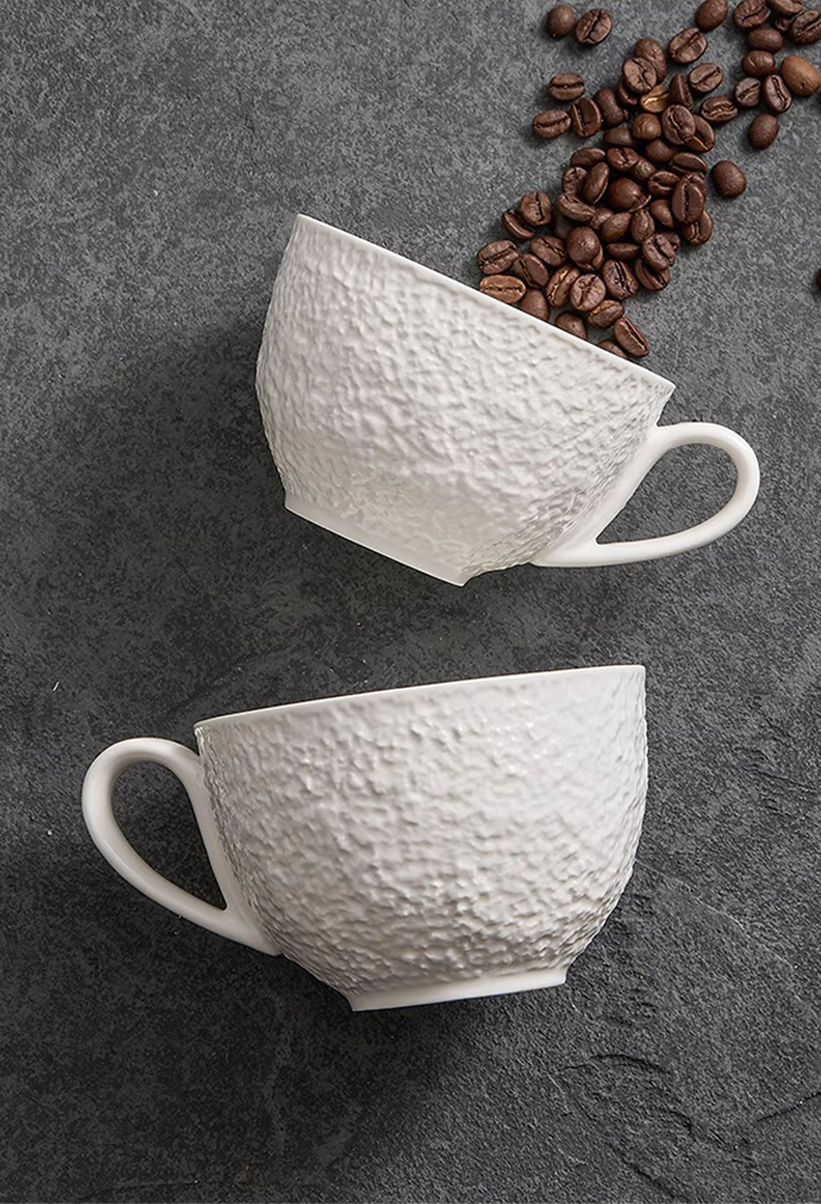 Porcelain cup showing textured craftsmanship and smooth interior