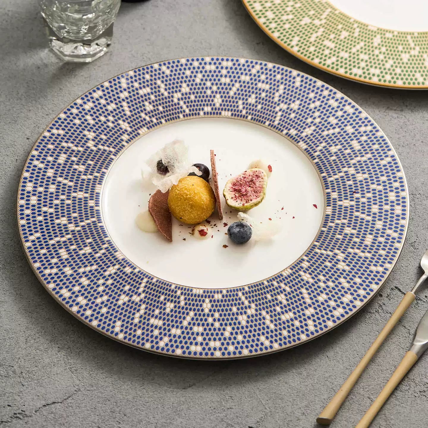 Premium porcelain dinner plate with a wide blue mosaic-patterned rim and gold trim.