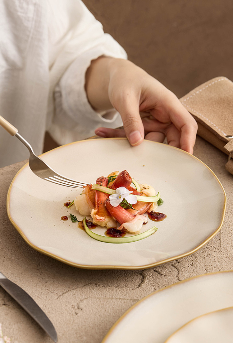 Professional-grade porcelain with a non-symmetrical wavy silhouette for contemporary table styling.