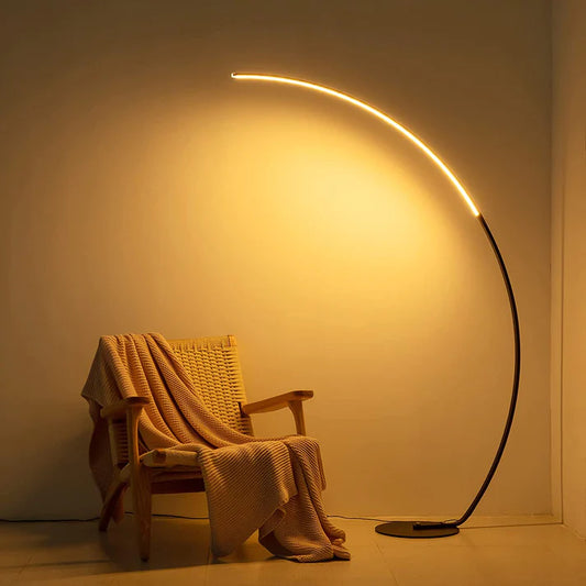 RGBW modern curved floor lamp in a standing position on wooden floor

