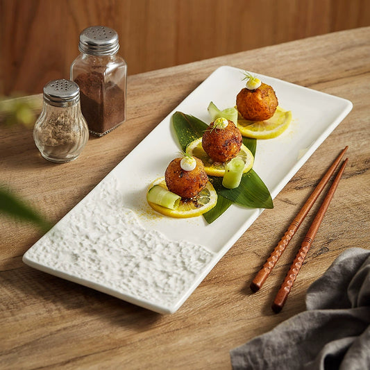 Rectangular ceramic plate with sculpted stone-textured rim

