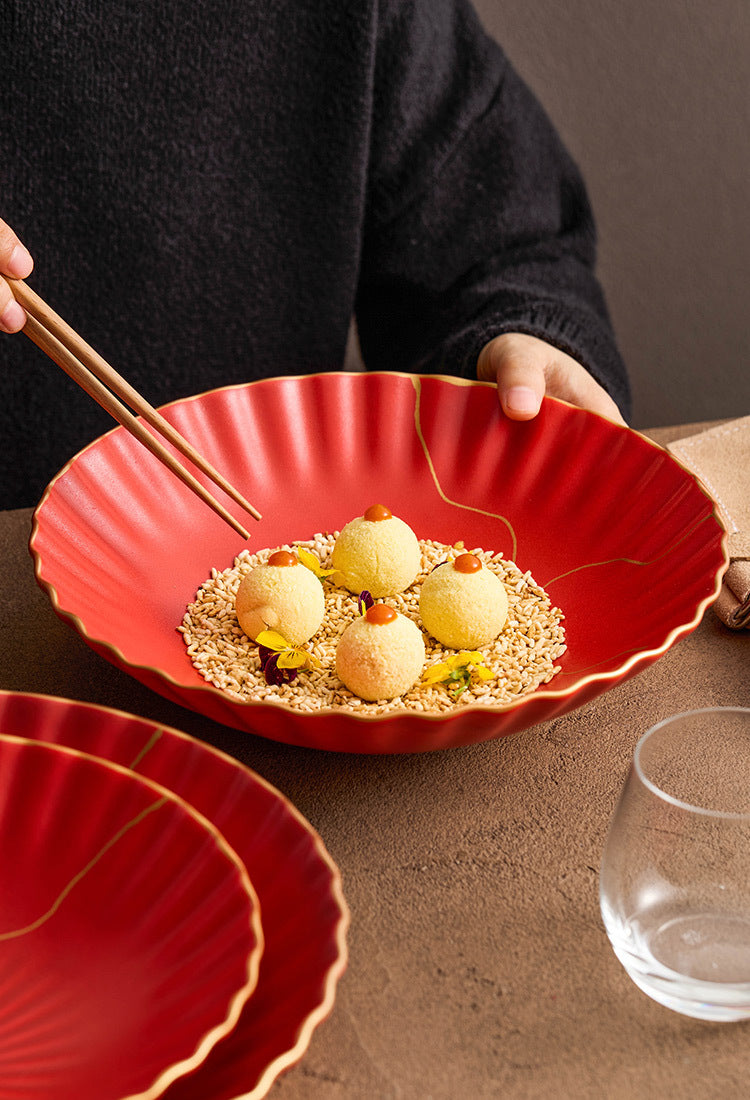 Red dish with food and chopsticks on a brown surface