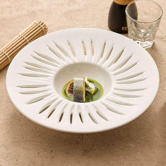 Sculptural matte white conical plate by GOSEUNG Tableware Collection.