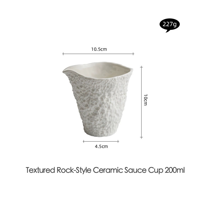Sculptural white ceramic cup for pouring sauce or dressing

