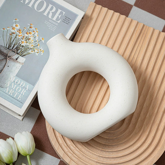 Minimalist Nordic-style vases arranged on modern round table


