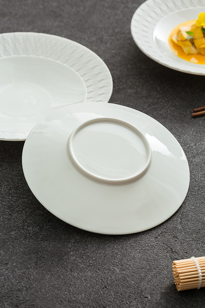Shallow dining plate with subtle embossed texture