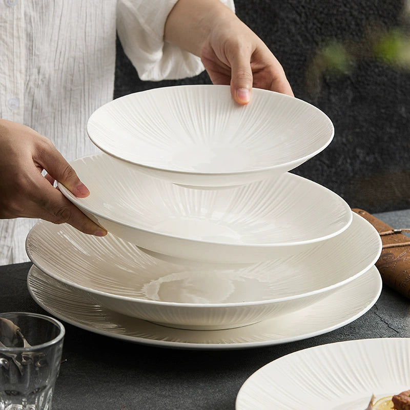 Shallow porcelain plate with sunray texture for modern home décor.
