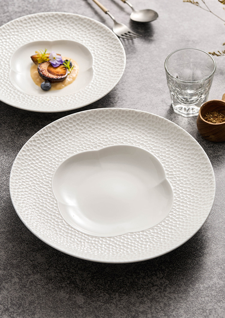 Side view of a deep-well blossom plate showcasing its sculptural 4.4 cm height.