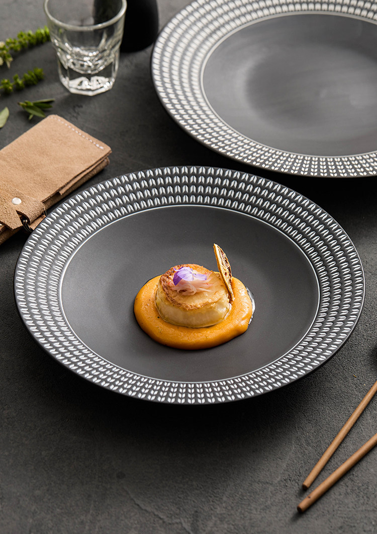 Side view of a shallow-rimmed ceramic dish with a substantial feel and durable porcelain build.