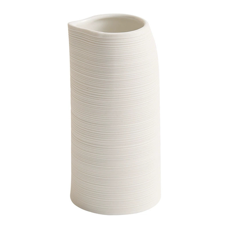 White ribbed vase on a white background