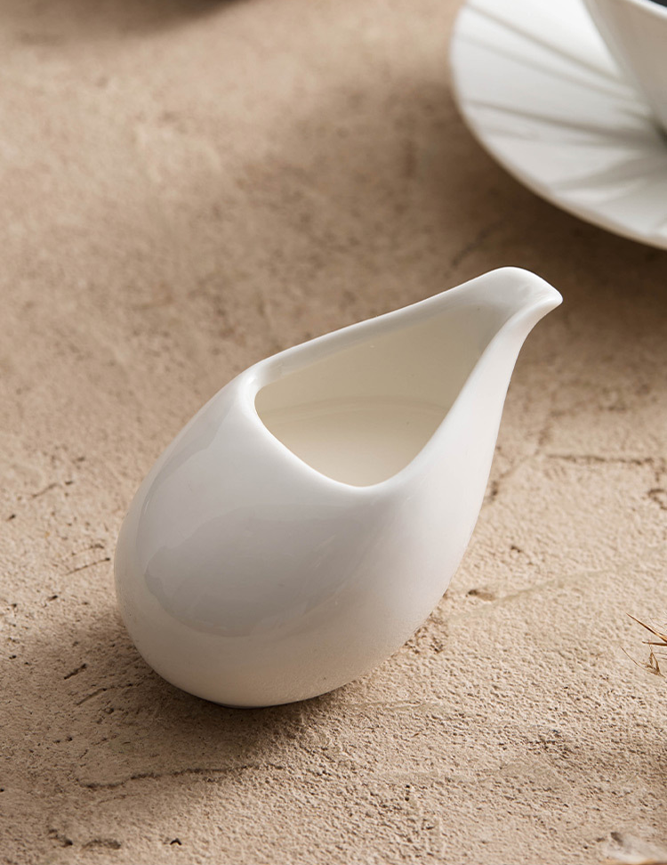 Small ceramic gravy boat for salad dressings, honey, and maple syrup.