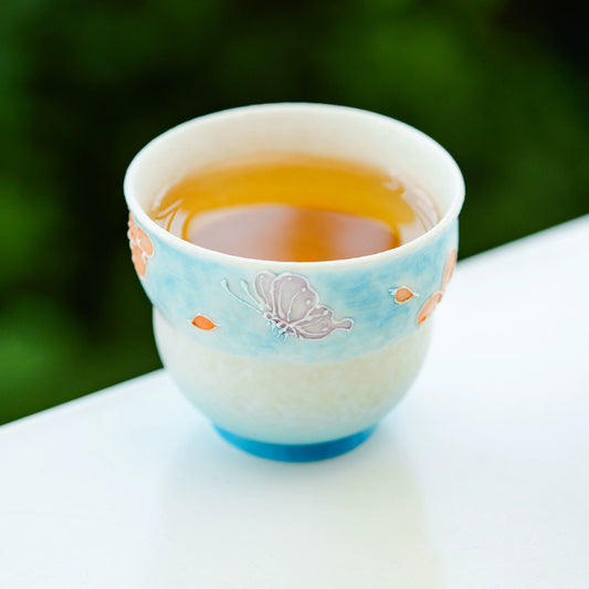 Small ceramic tea cup inspired by traditional prosperity symbols