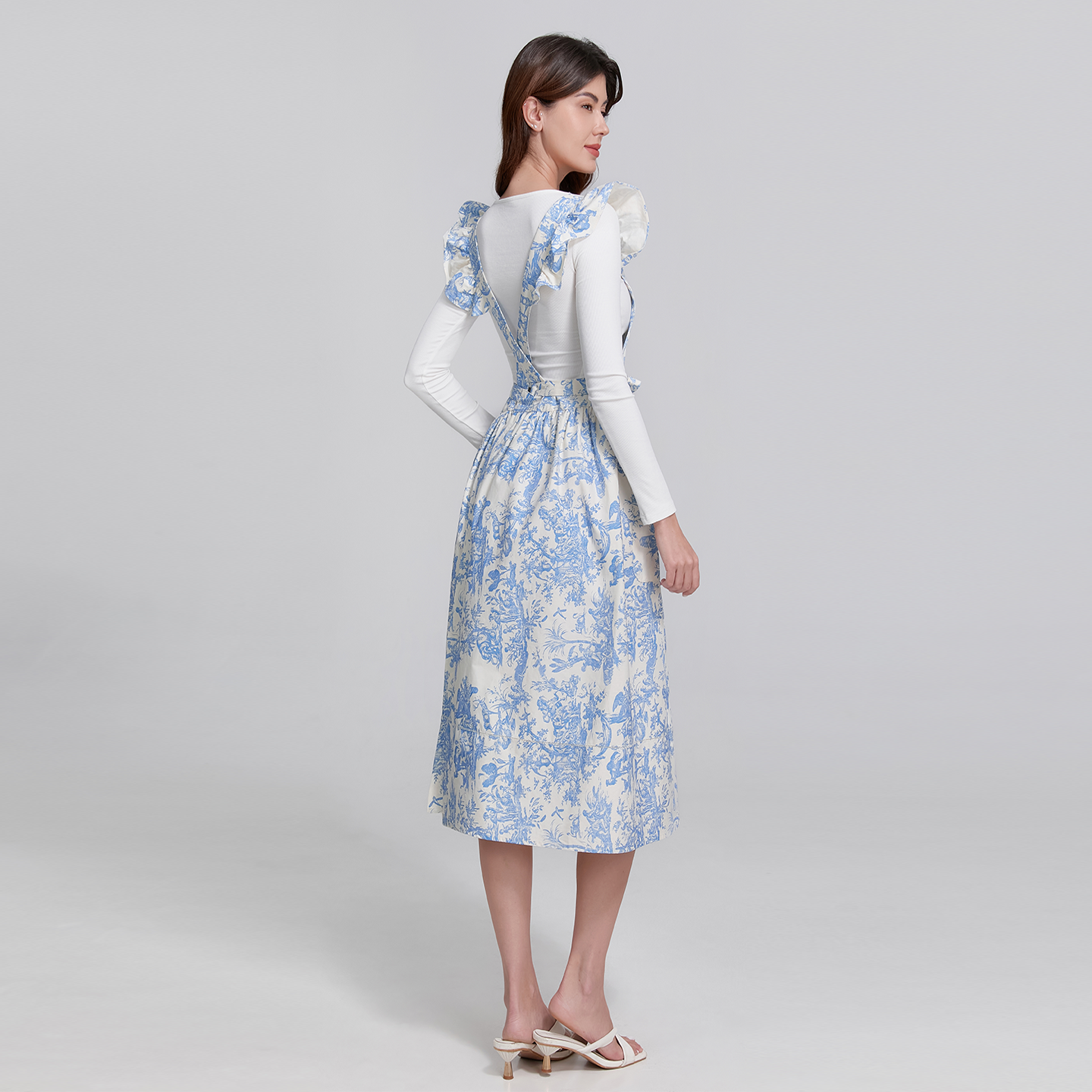 Sophisticated blue apron with graceful hemstitch detailing and a feminine ruffle hemline.