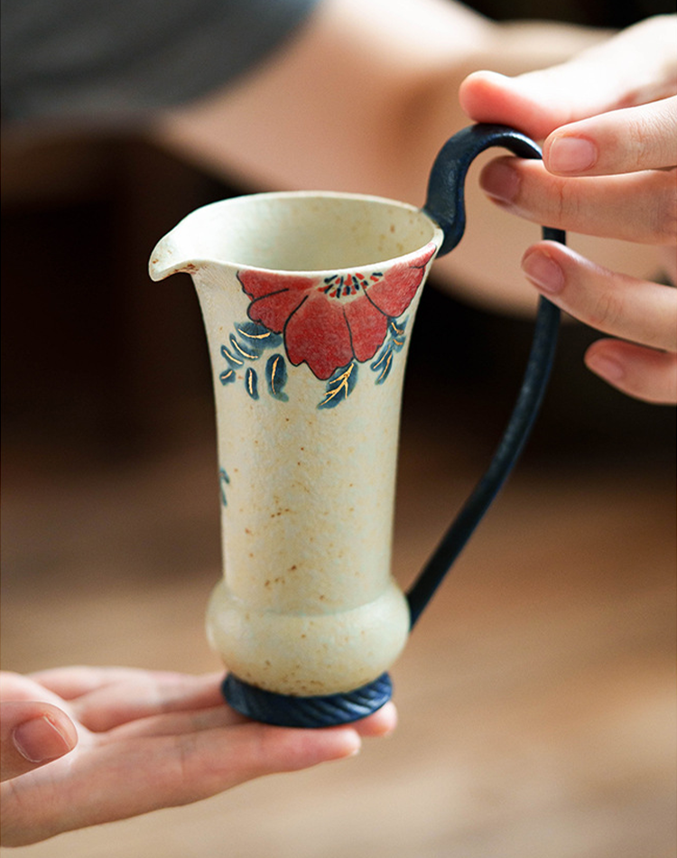 Speckled ceramic jug with floral artwork and matte finish
