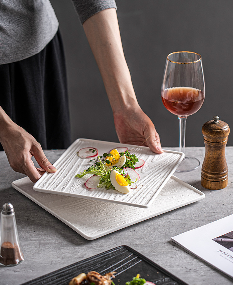 Square ceramic plate with textured surface for food presentation