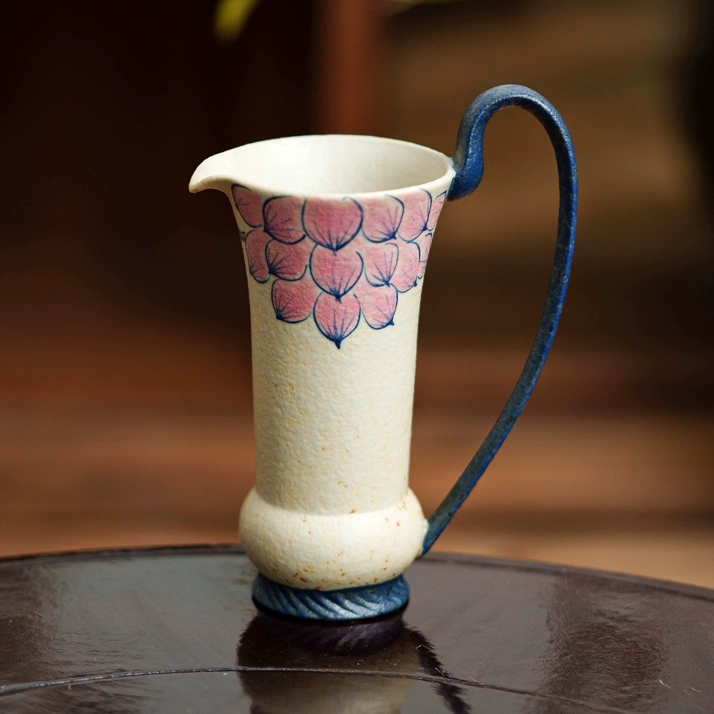 Tall ceramic jug with hand-painted flower design