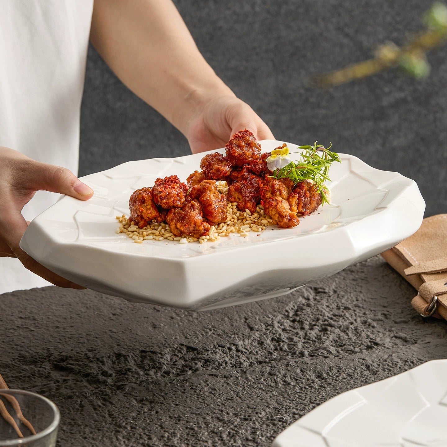 Textured porcelain serving plate with glossy finish.