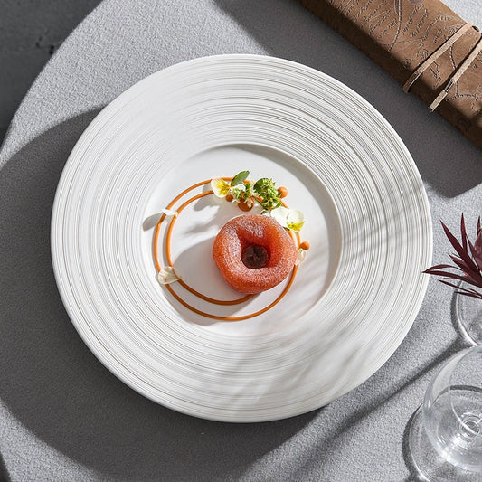 Delicate dessert presentation on a white plate with a gray background