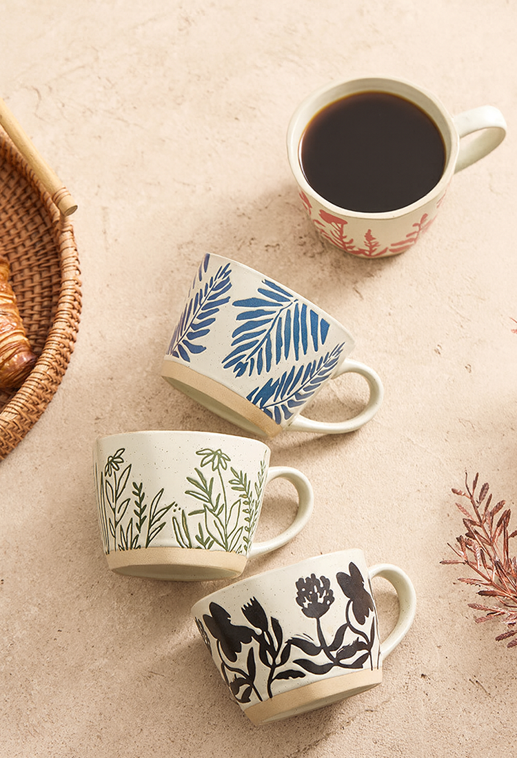 Textured stoneware mug with floral and garden motifs