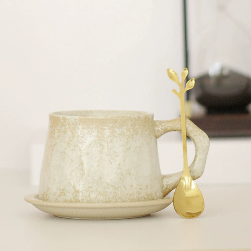 Top view of Japanese ceramic cup with spoon on saucer

