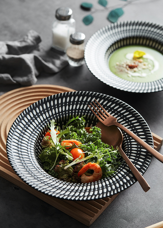 Top view of printed ceramic pasta plate with wavy rim

