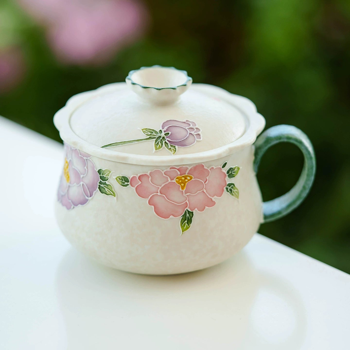 Traditional floral ceramic tea cup with handle