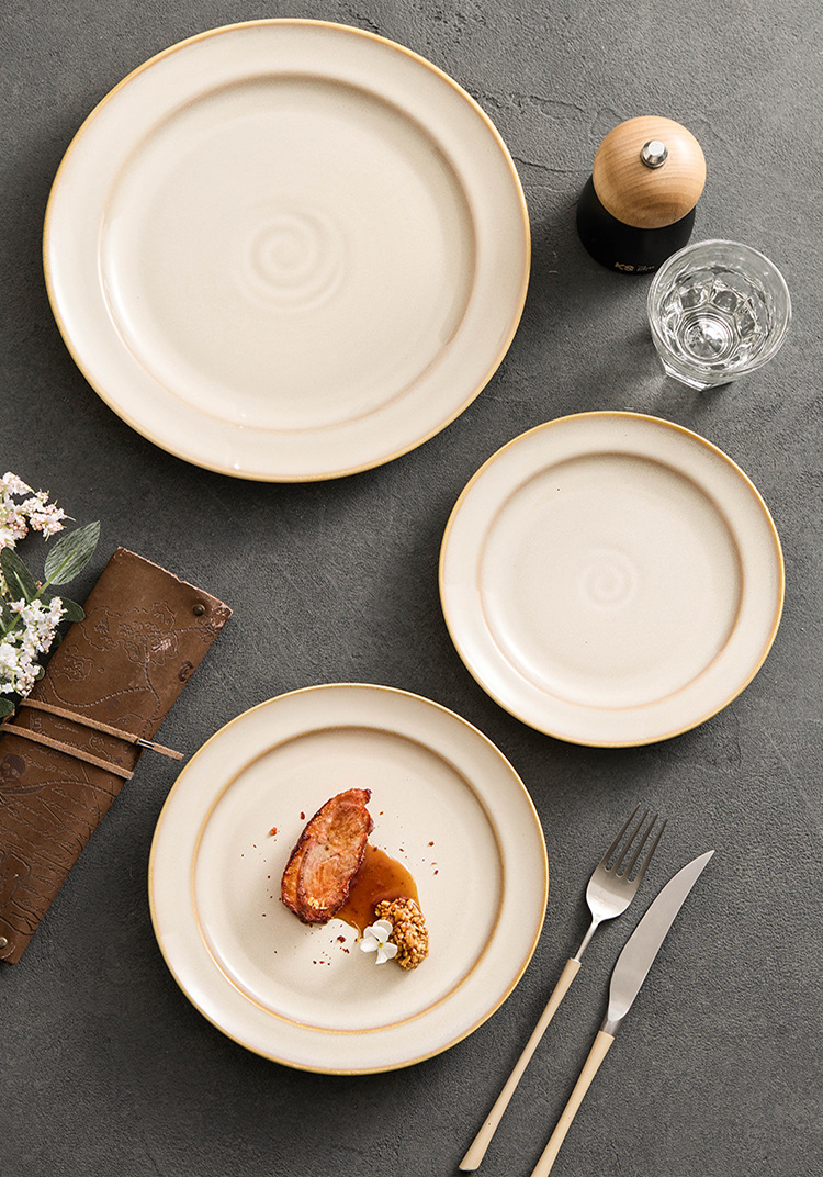 Trio of circular kiln-fired plates representing the quiet perfection of form.