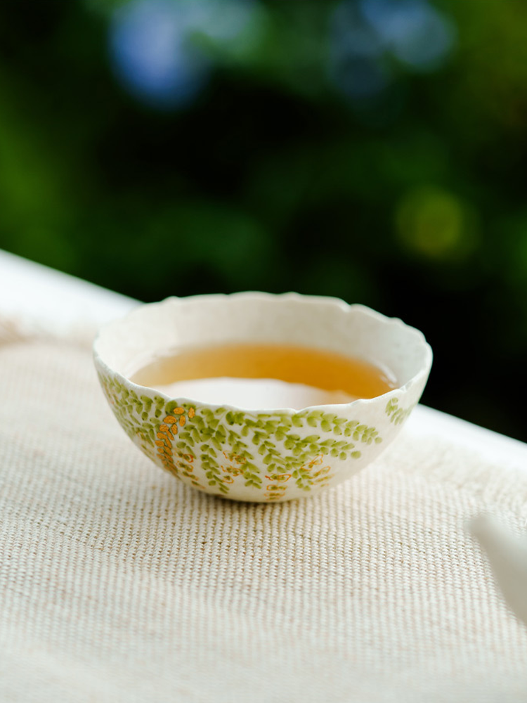 Unique handmade ceramic teacup with golden details