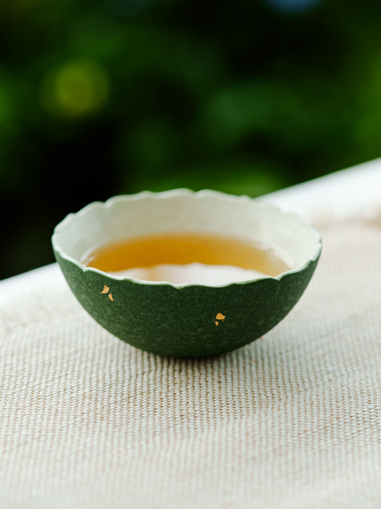Unique handmade green ceramic cup for jasmine tea