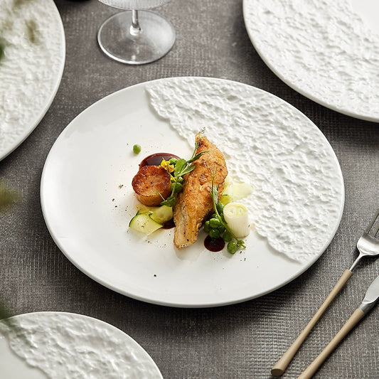 White ceramic dinner plate with asymmetric stone texture


