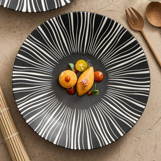 White ceramic dinner plate with burst stripe design

