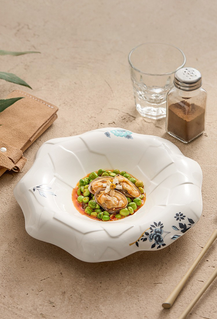 White porcelain bowl with smooth glazed interior and wavy rim.