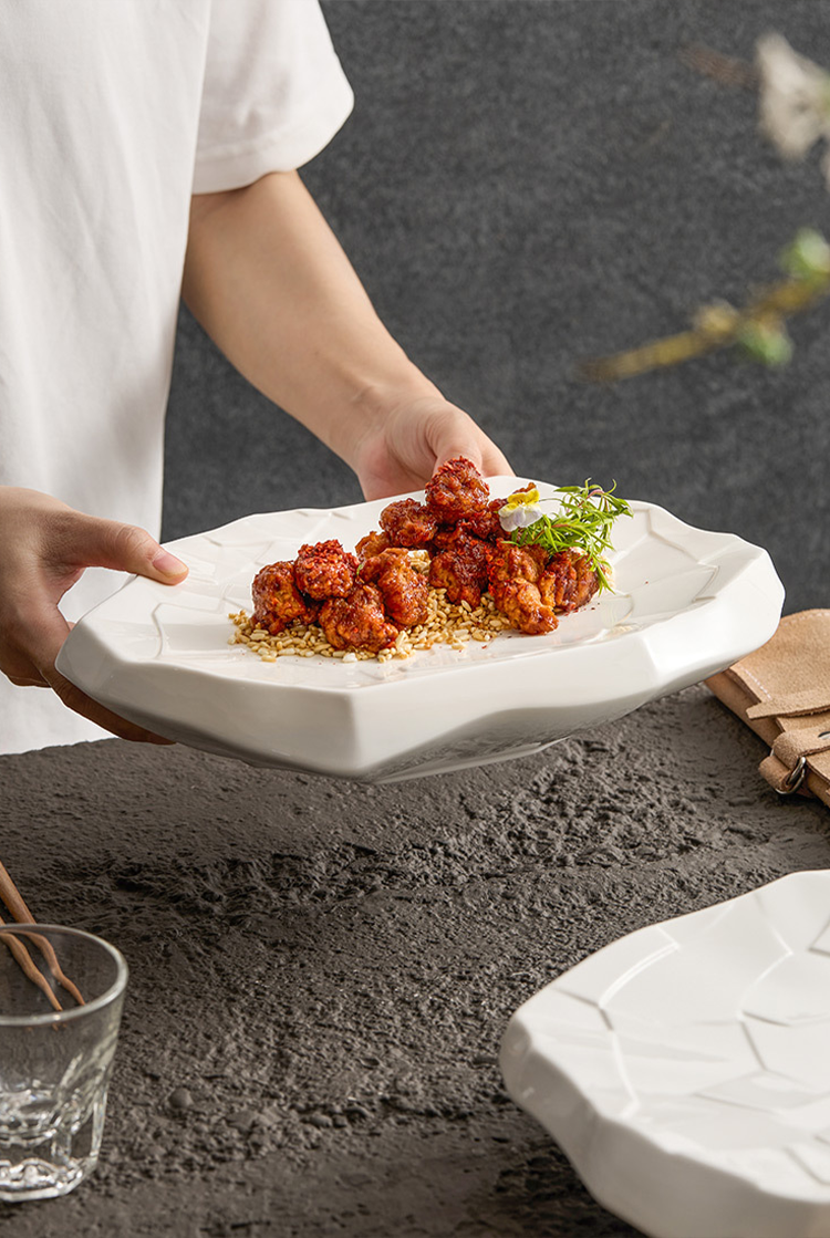 White porcelain plate with organic irregular contour.