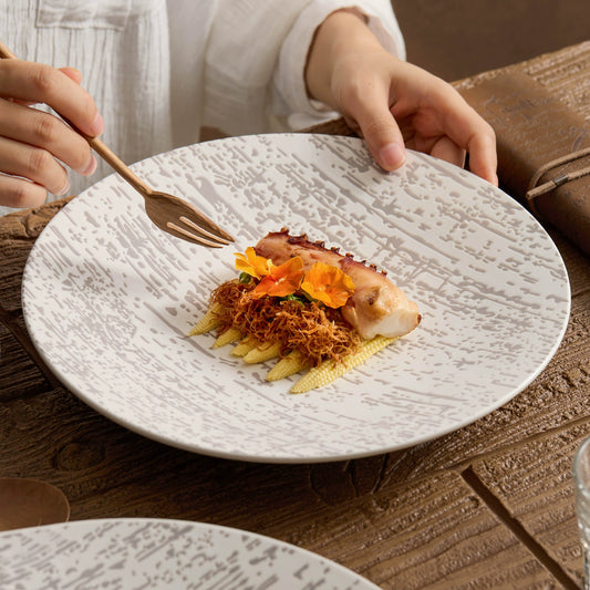 White round ceramic plate with subtle gray patterns