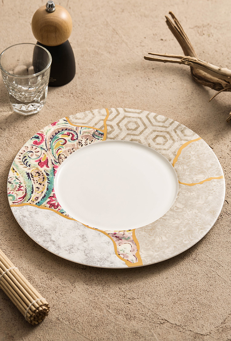 Wide-rim porcelain dinner plate with artistic patchwork and gold inlay