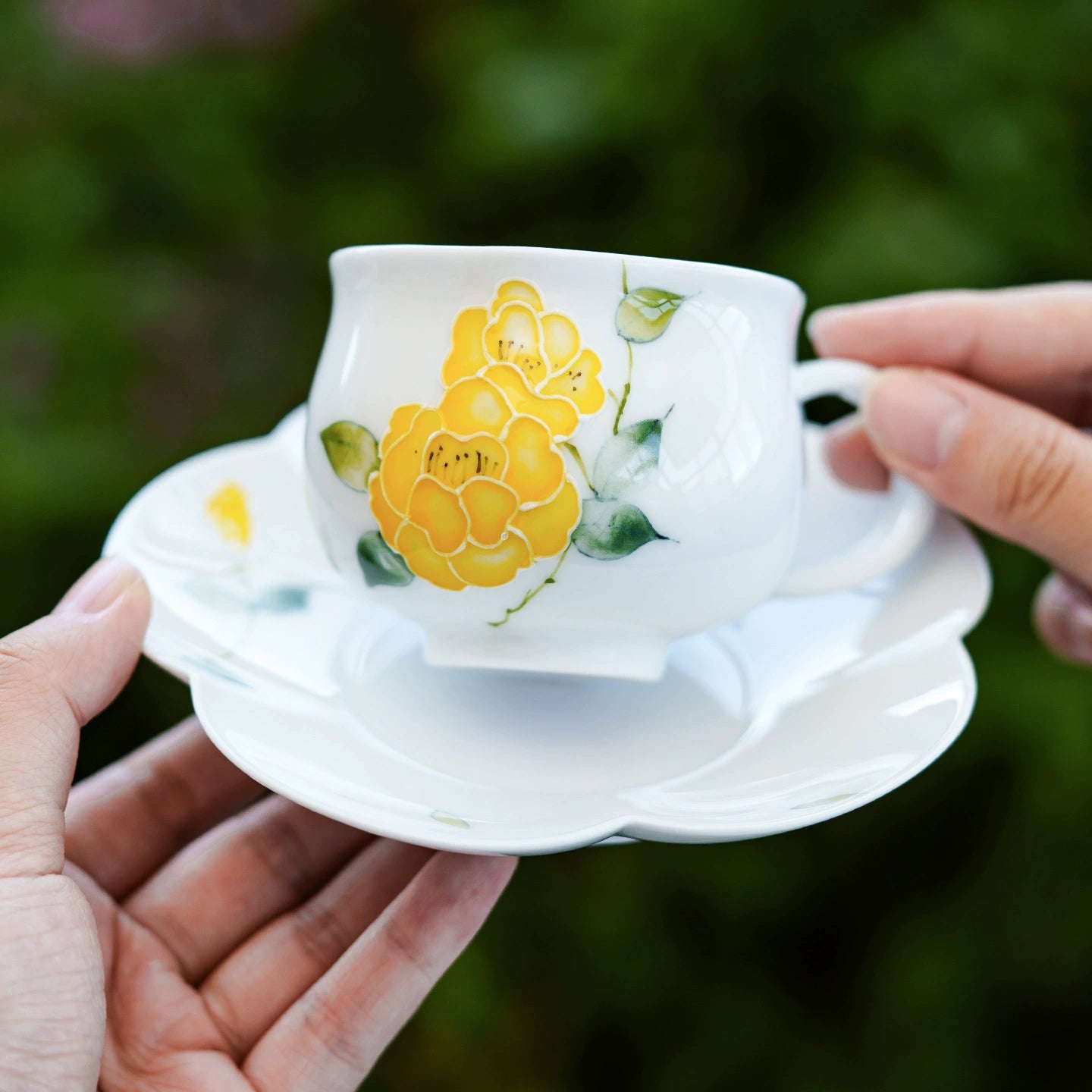 Yellow flower porcelain teacup with matching saucer