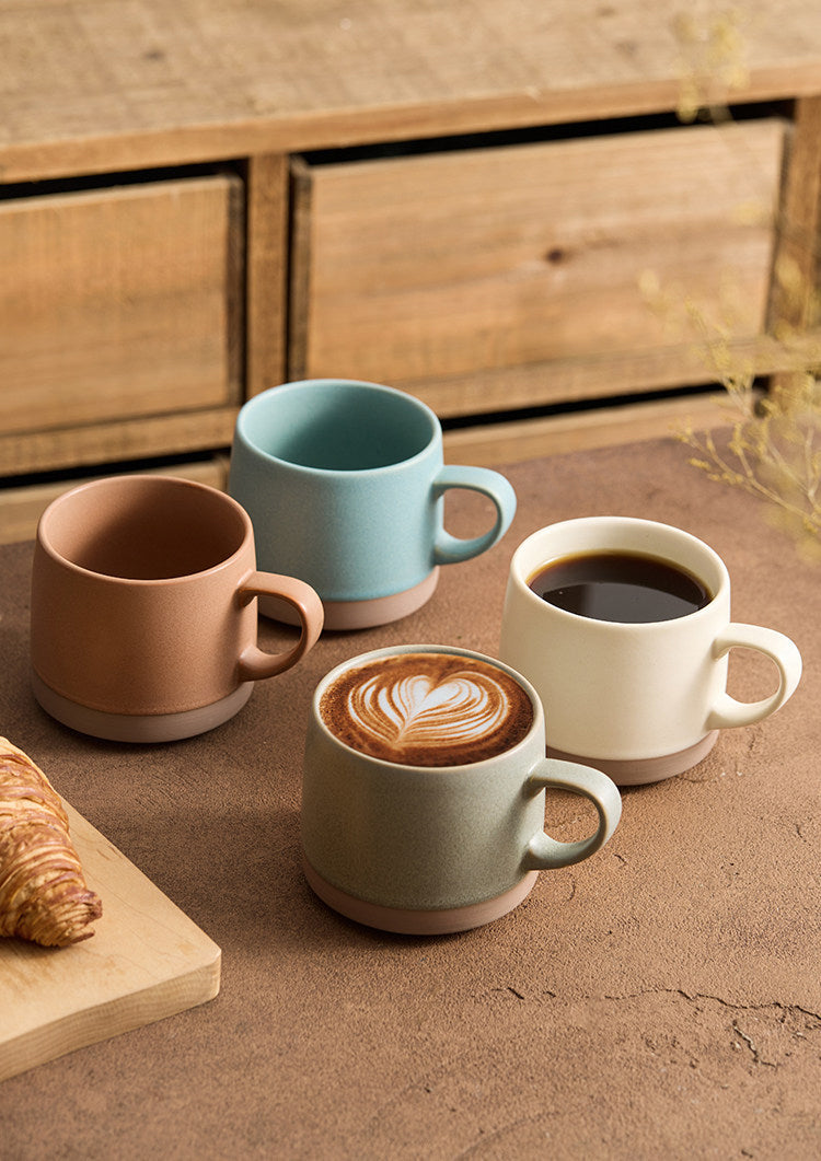 four goseung aurora mugs on wooden table with latte art and croissant 1