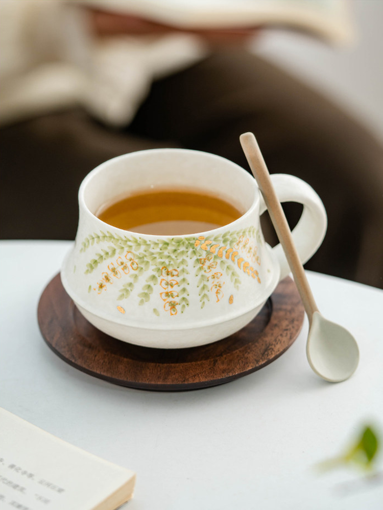 hand crafted porcelain cup with cascading floral relief pattern