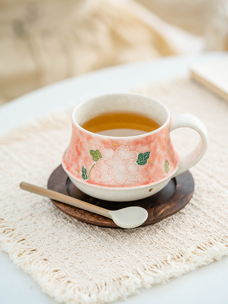 hand crafted porcelain cup with tactile 3D flower relief pattern