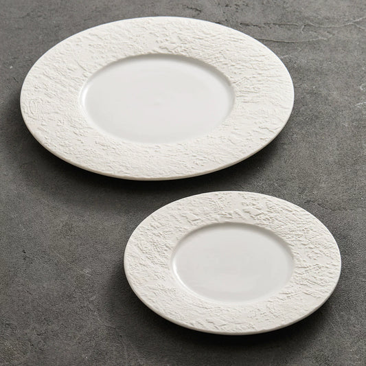 minimalist white porcelain dinner plate with wide textured stone borders