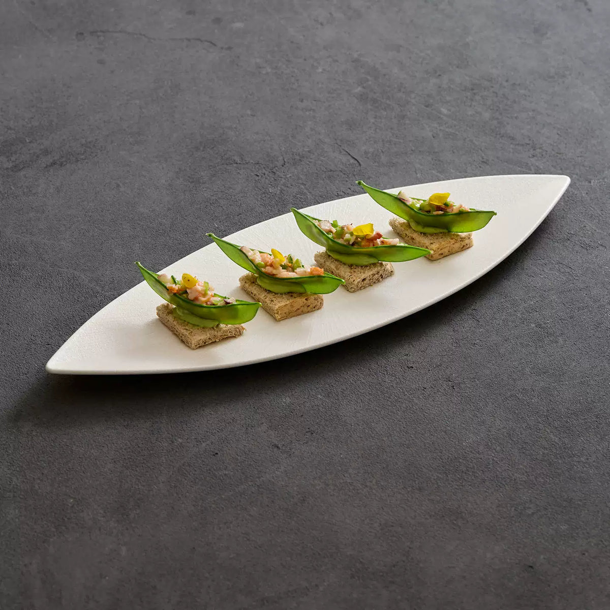 white elongated gondola dish for sushi and sashimi plating
